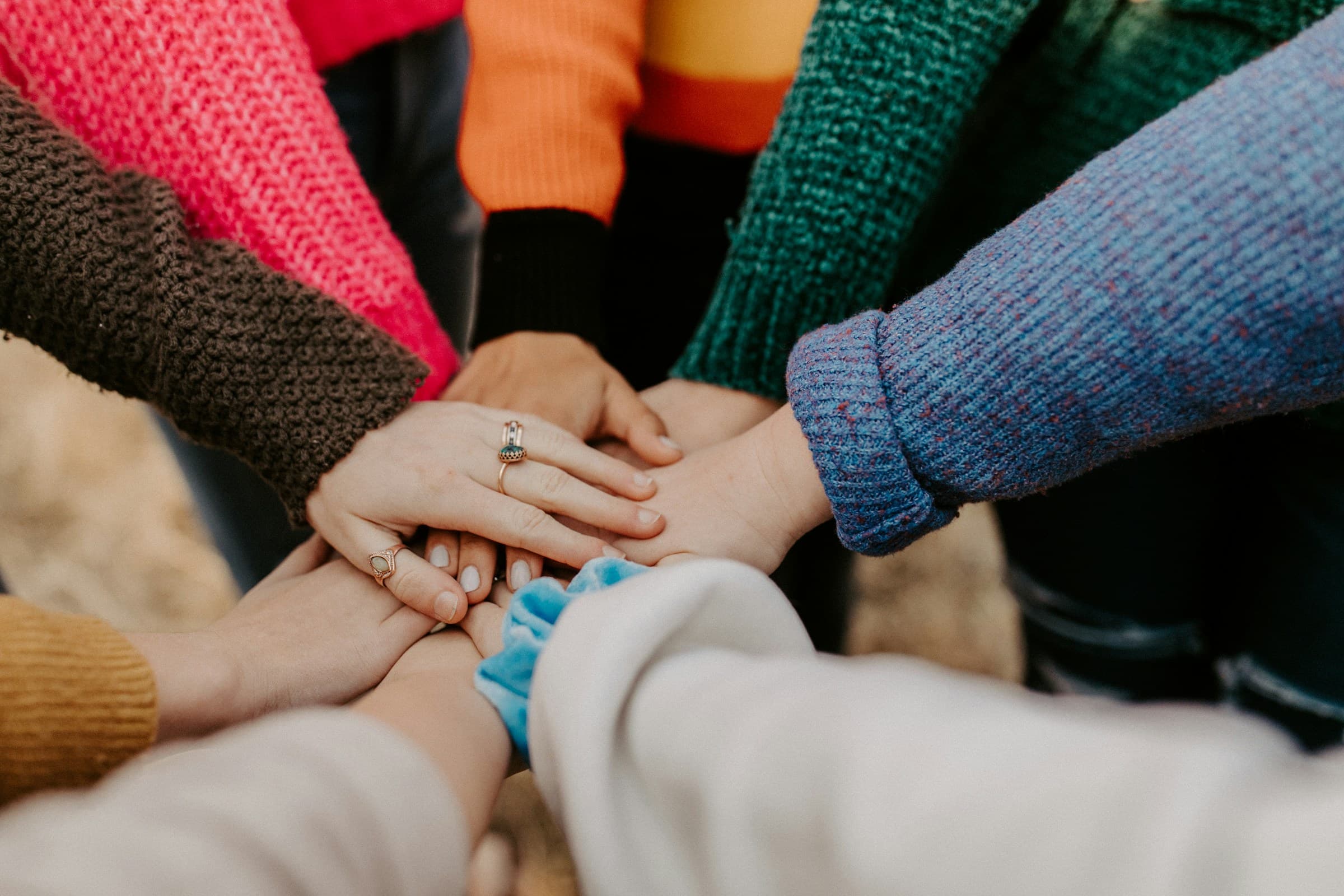 Group of people stacking their hands together